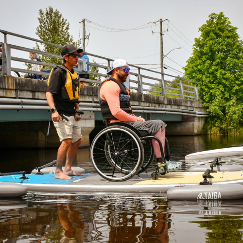 Two paddlers on the TAIGA Adaptive SUP