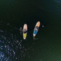 Two paddle boards on a body of water from an aerial perspective