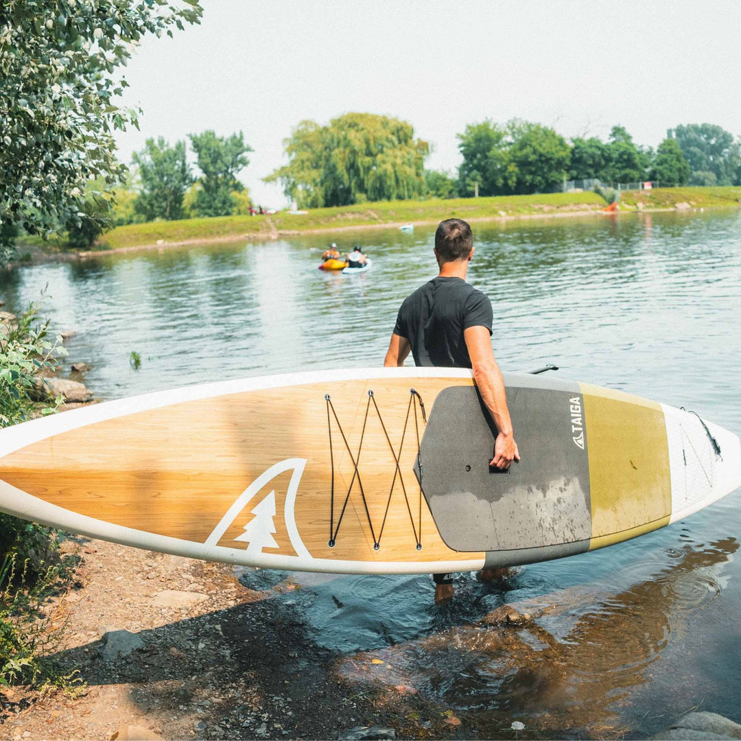 Paddler holding the Kazuzu 12'6 Pine