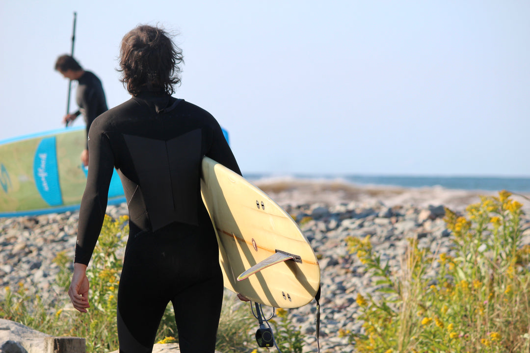 Surfers in a wetsuit with boards