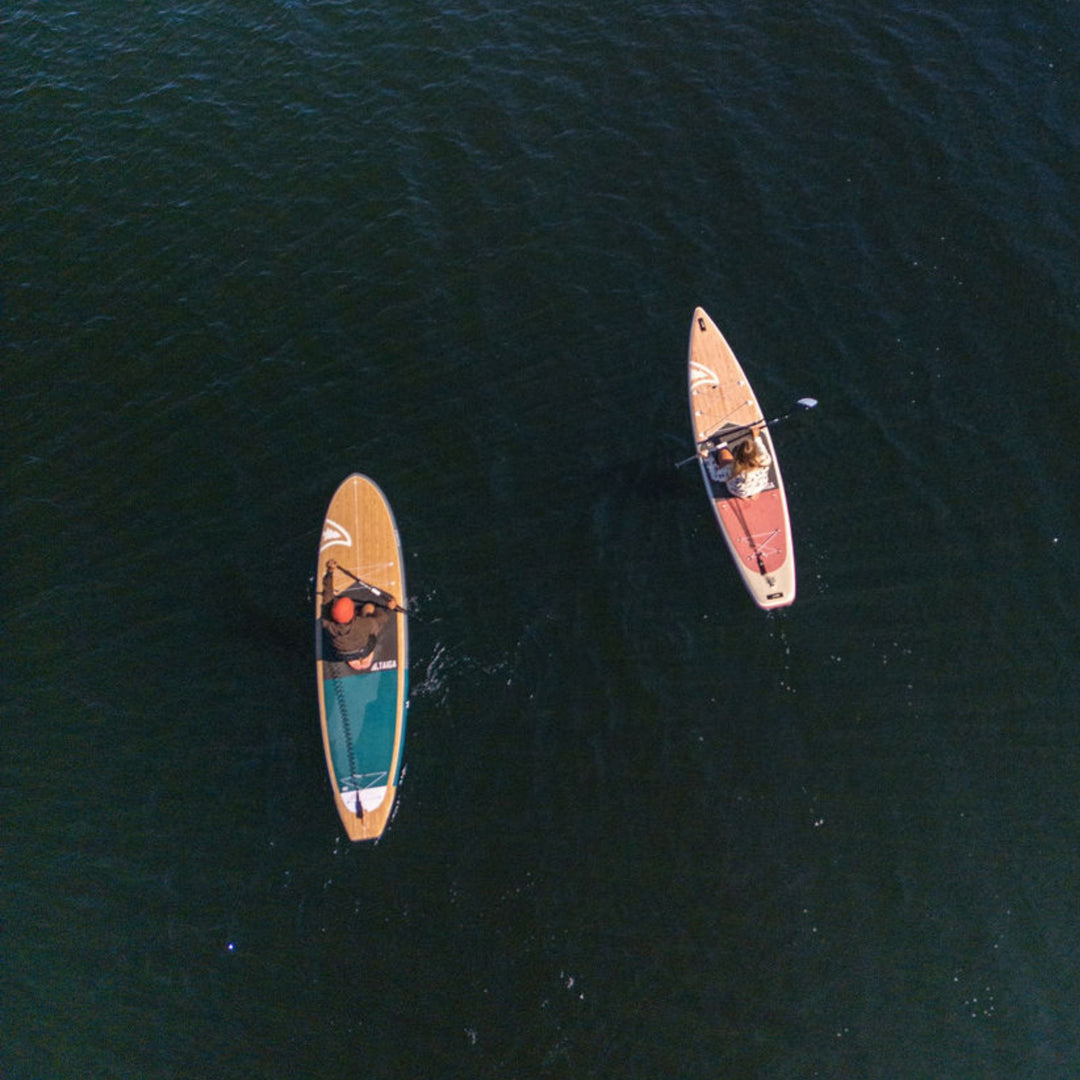 Two paddleboards on a body of water from an aerial perspective