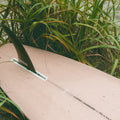 Fin View of The Longboard Surf Board in The Rosé Color