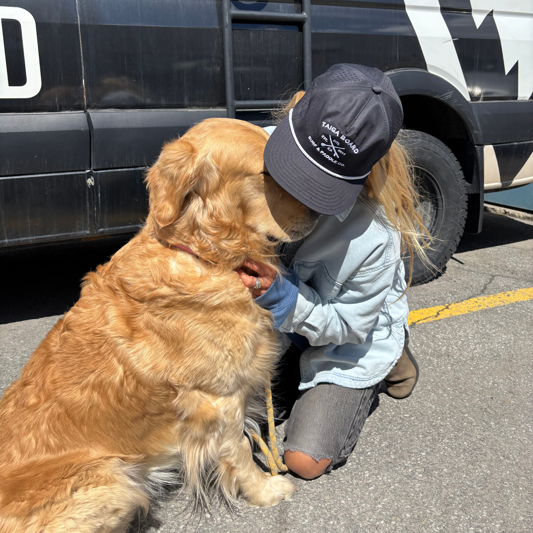 Girl Wearing the Mesh Surf & Paddle Co. Cap with her dog  