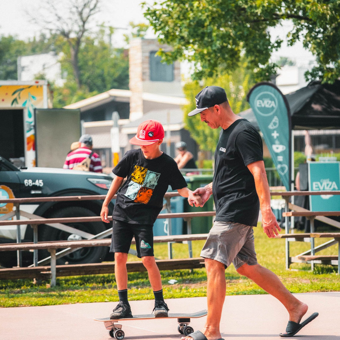 Kid skateboarding on the Surfskate By TAIGA with his dad