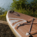Wooden inflatable paddleboard near water