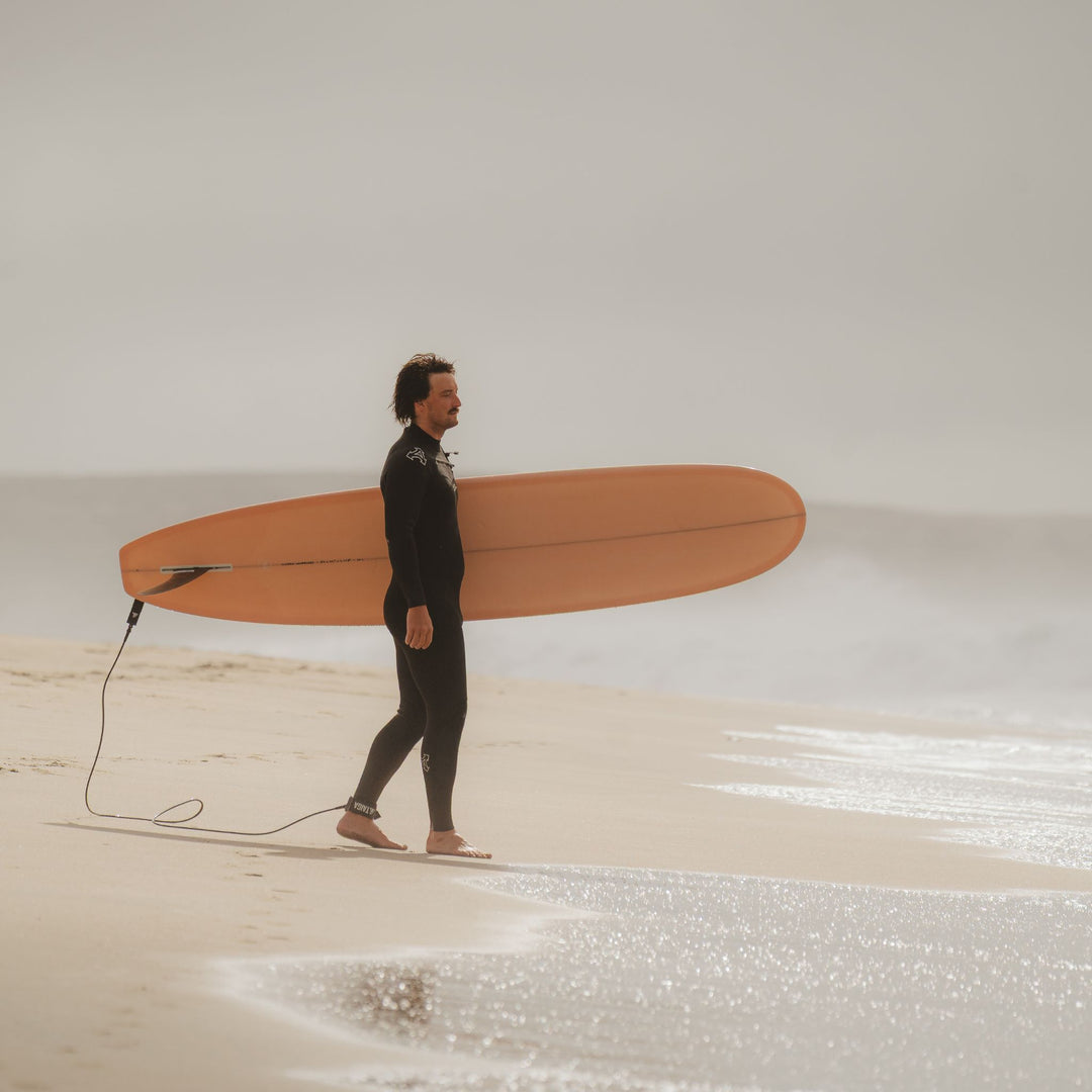 Surfer holding a pink board
