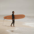 Surfer holding a pink board