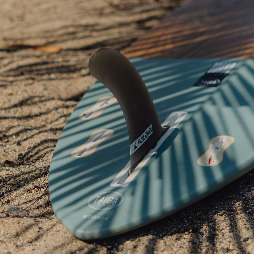 Fin of a Wooden surfboard in the shade