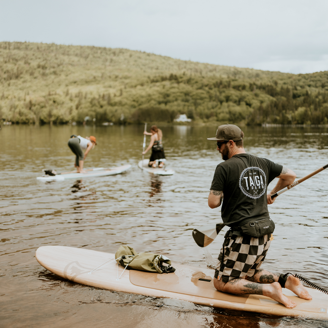 Paddler with the Diamond Asymetric Carbon Wood Paddle from TAIGA on a lake