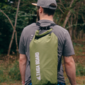 Boy with the 20 L DRY BAG by TAIGA on his back - Green