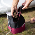 Paddler filling the Anchor for Paddle Board with sand - Burgundy 